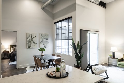 an open living room and dining room with a large window and a table